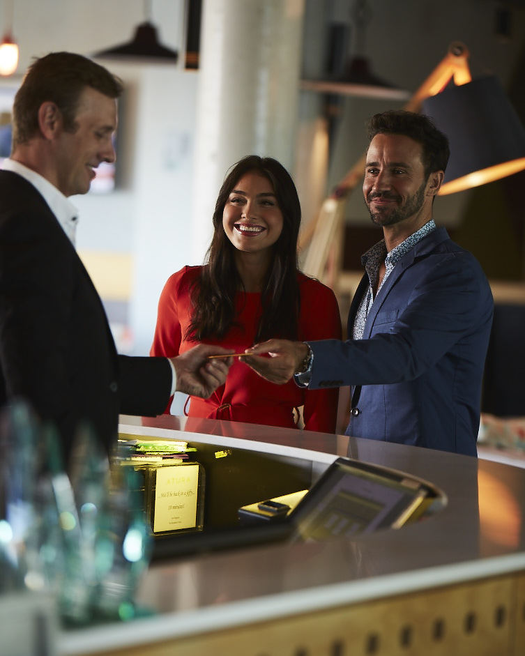 two people checking in to a hotel