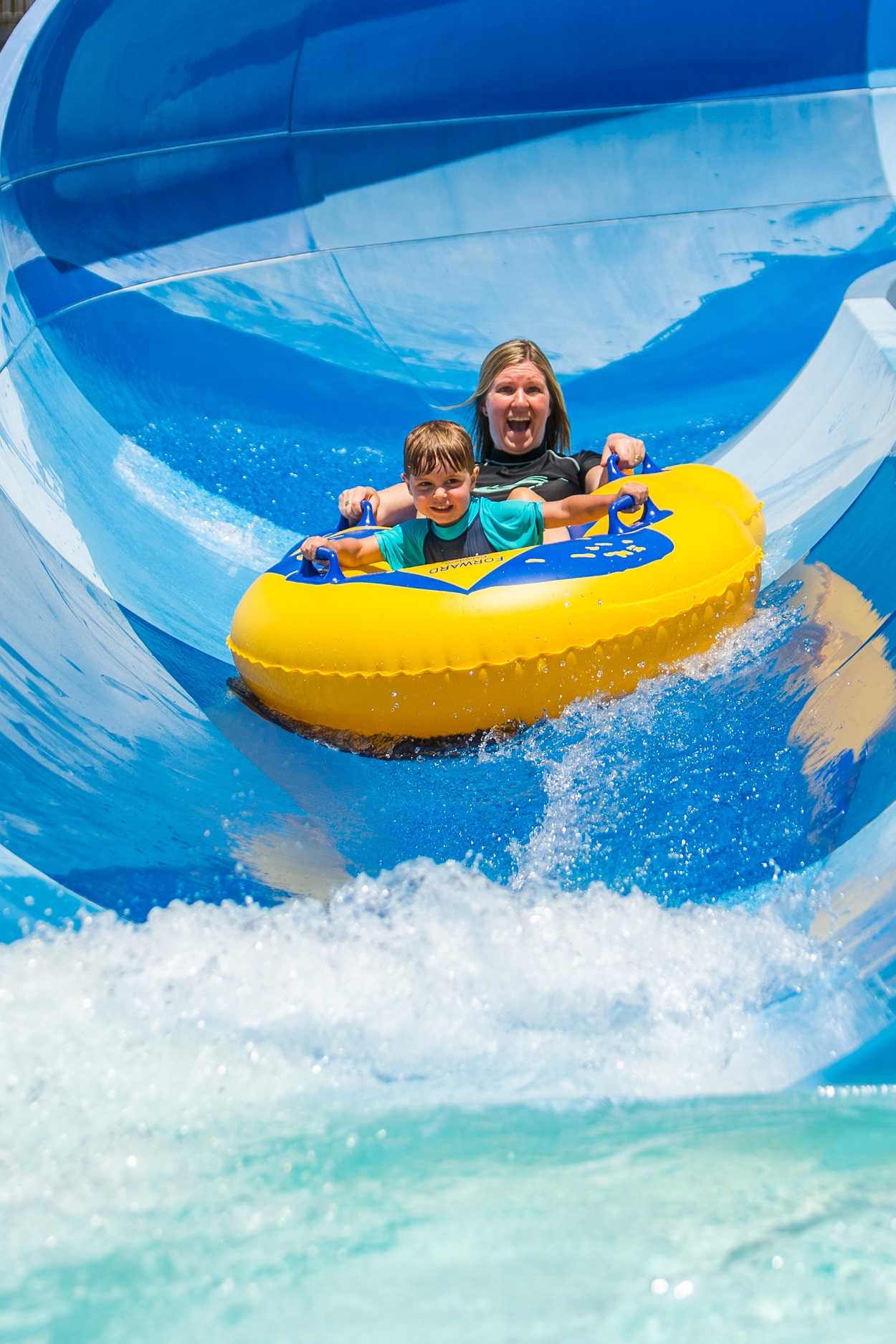 mum and son on blue water slide