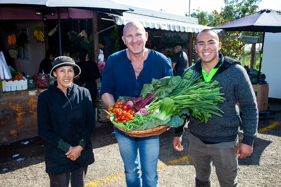 Matt Moran holding a basket of Mrs Sun's veggies take from Western Sydney Parklands Urban Farms