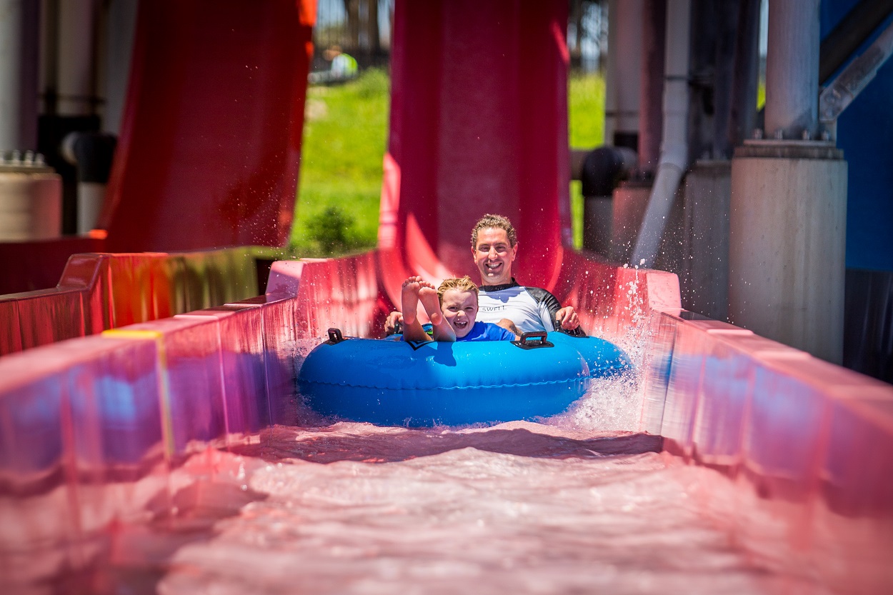 mum and son on red water slide