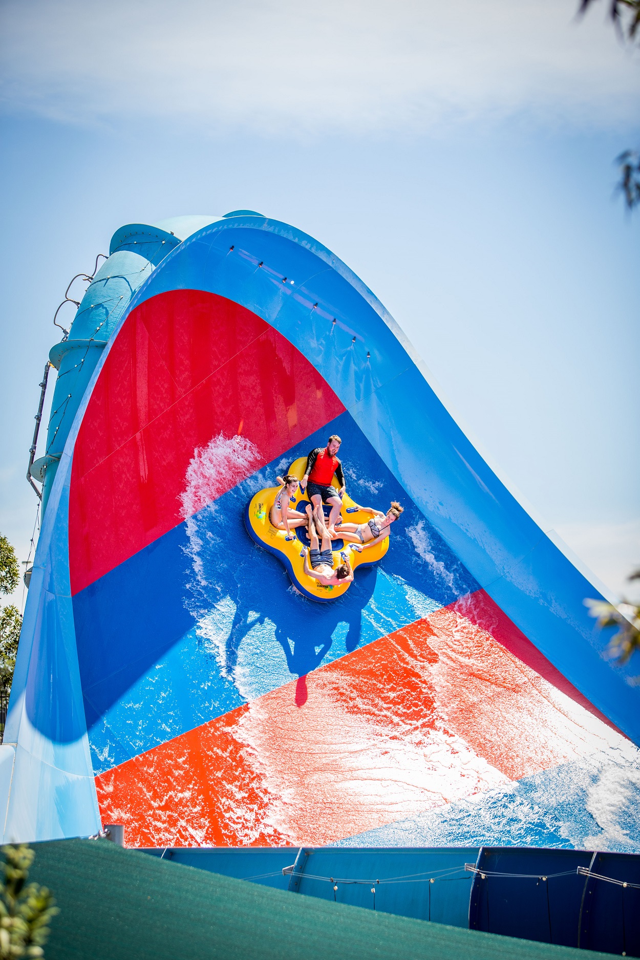 huge water slide with 4 people on a tube