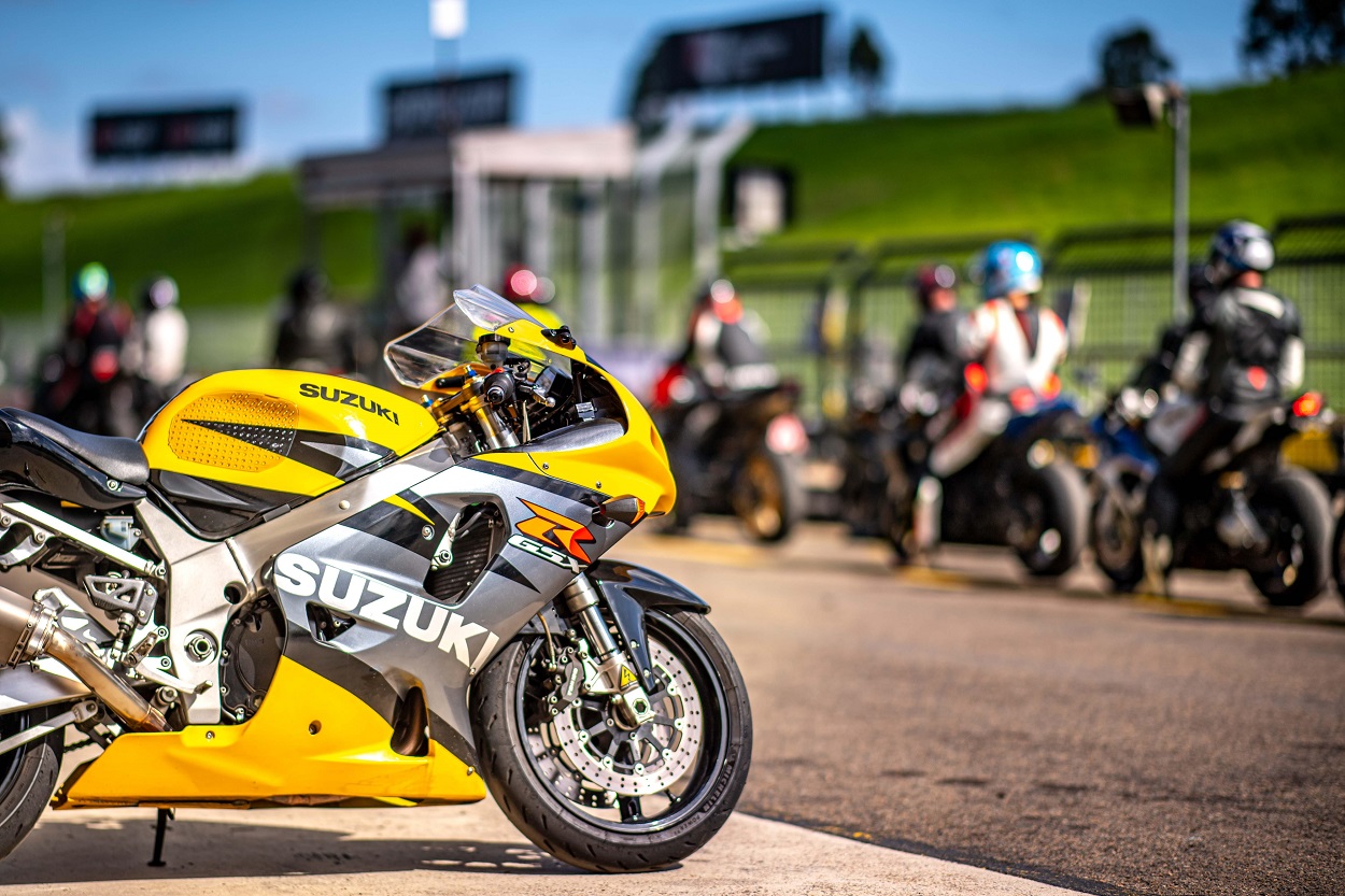 yellow motorbike with racers in the background